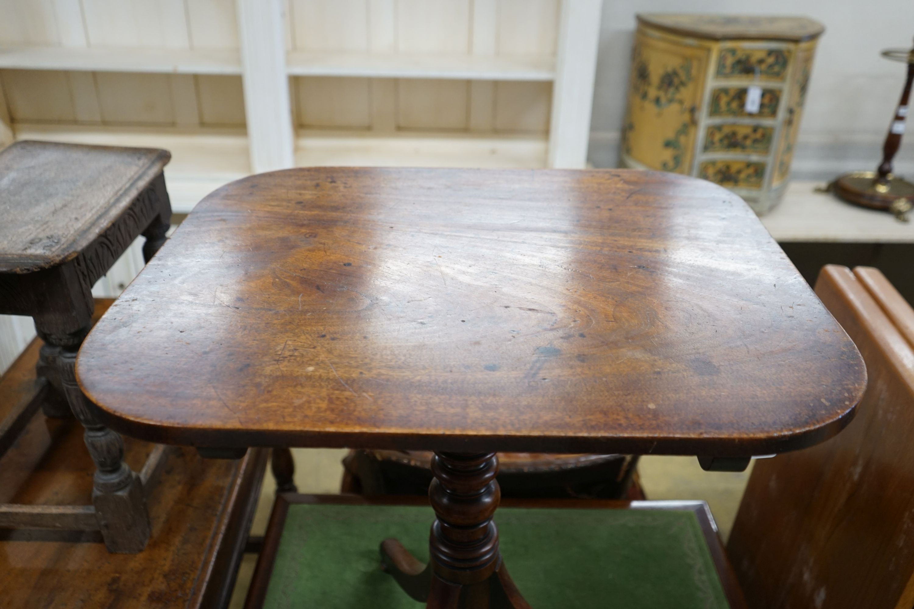 An early 19th century mahogany rectangular tilt top tripod table, width 64cm, depth 54cm, height 69cm